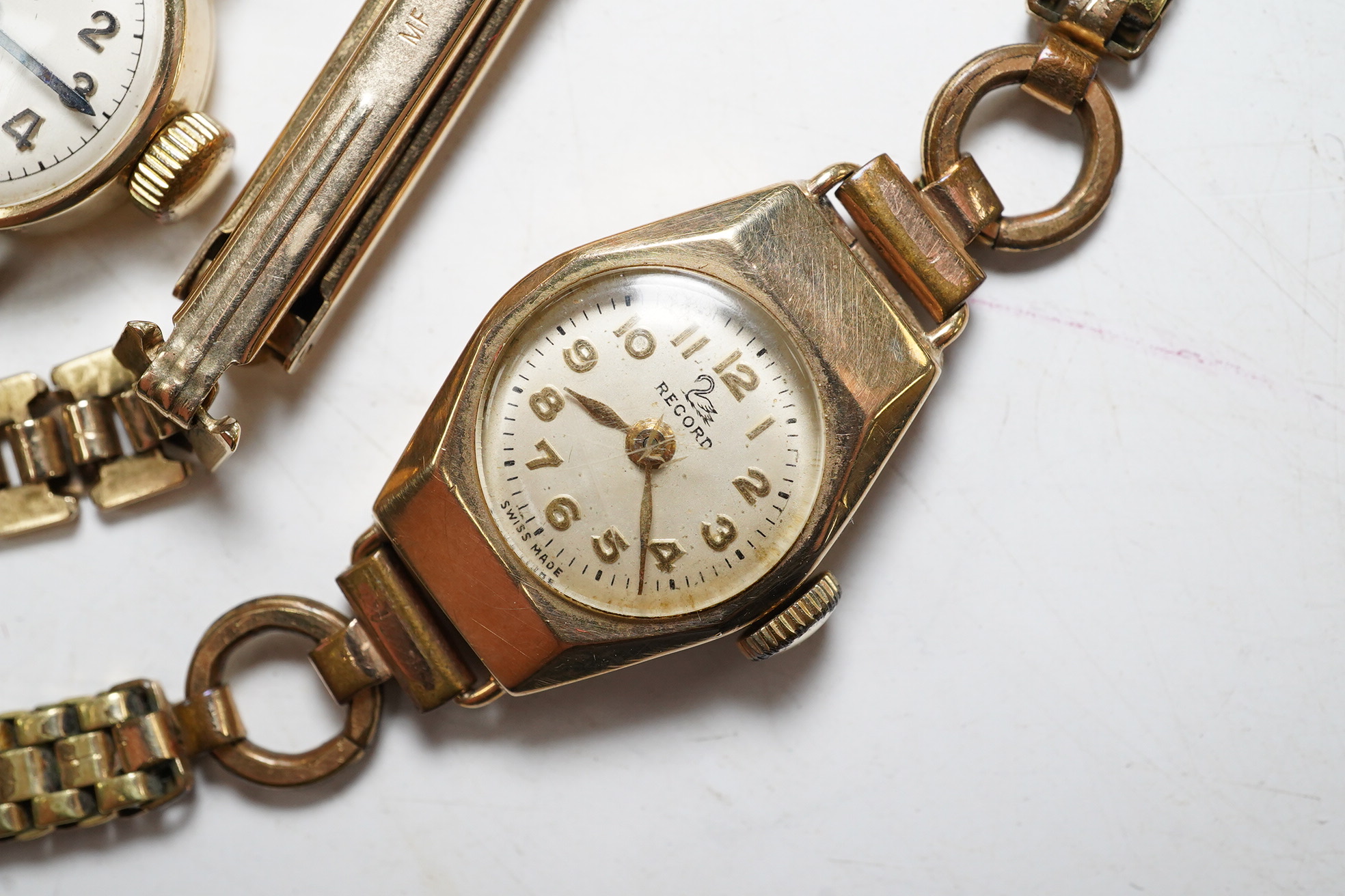 A ladies 9ct gold Rone Incabloc wrist watch with gilt strap and original box, a 9ct gold Record wrist watch with gold plated bracelet, and a gentleman's 9ct gold Rone Incabloc wrist watch in original box (3). Condition -